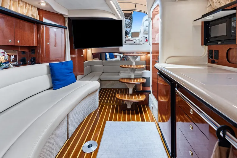 Slide: The Image of Luxurious interior of 2003 Sea Ray 340 Sundancer yacht with elegant seating and modern amenities. - 7