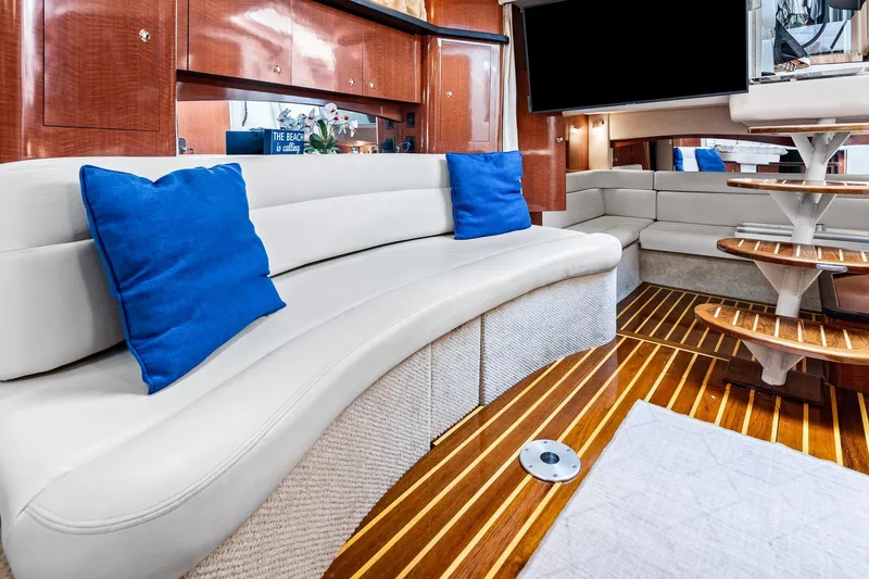 Slide: The Image of Luxurious interior of 2003 Sea Ray 340 Sundancer yacht with plush seating and wooden flooring. - 8