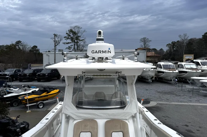 Slide: The Image of 2021 Sea Fox 328 Commander boat interior with cushioned seating and cup holders. - 21