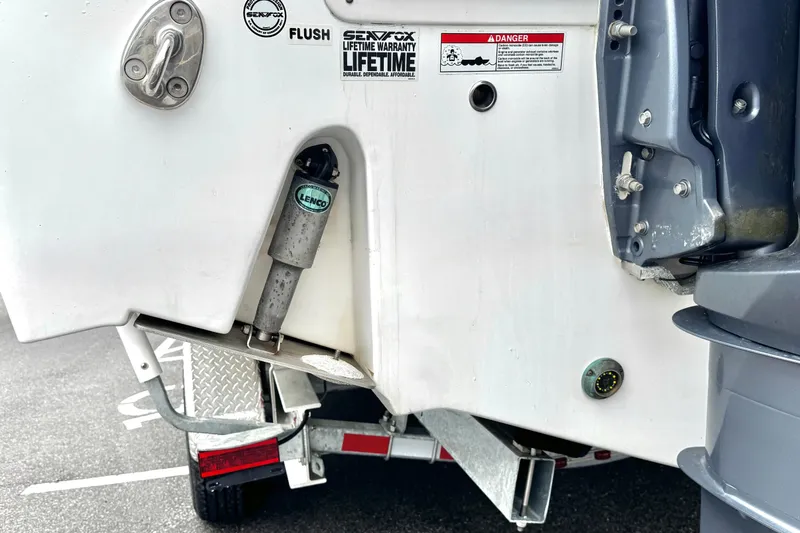 Slide: The Image of Rear view of 2021 Sea Fox 328 Commander boat with Lenco trim tab and trailer. - 44