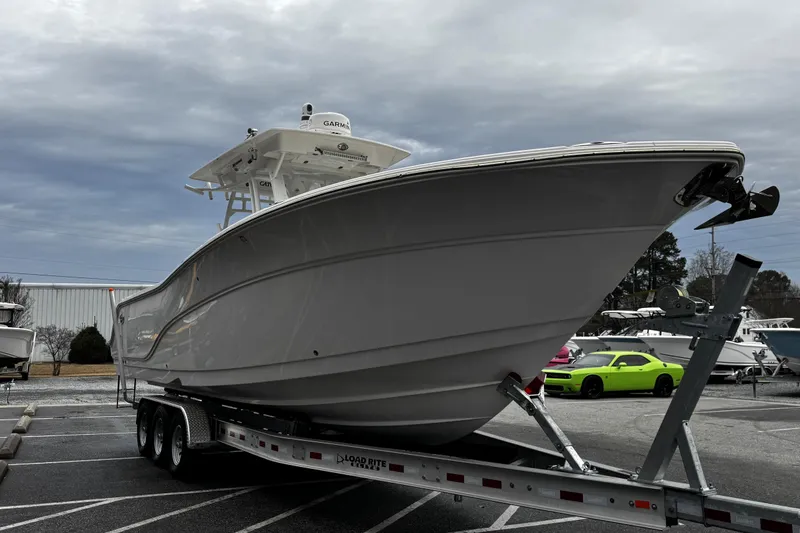 Slide: The Image of 2021 Sea Fox 328 Commander boat with dual Yamaha 300 engines, parked outdoors. - 5