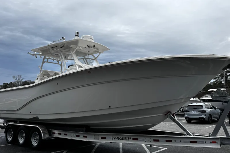 Slide: The Image of 2021 Sea Fox 328 Commander boat on trailer, parked outdoors under cloudy sky. - 6