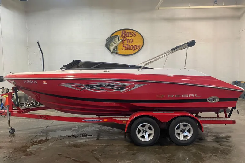 The Image of 2008 Regal 2000 Bowrider boat in showroom, red with custom graphics, on trailer. - 0