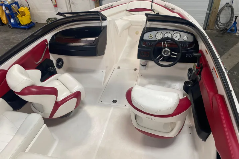Slide: The Image of 2008 Regal 2000 Bowrider interior with red and white seating, steering wheel, and dashboard. - 12
