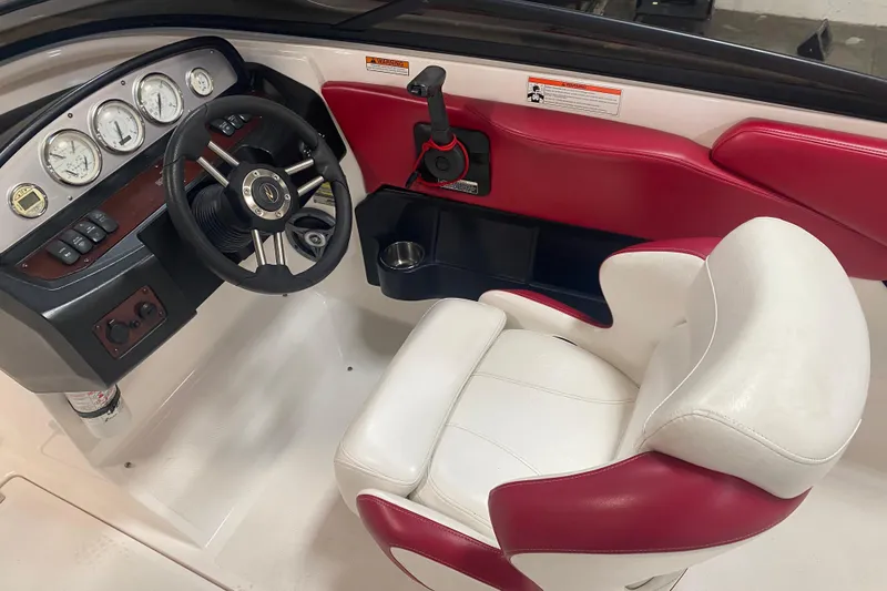 Slide: The Image of 2008 Regal 2000 Bowrider interior with steering wheel and red-white seating. - 13