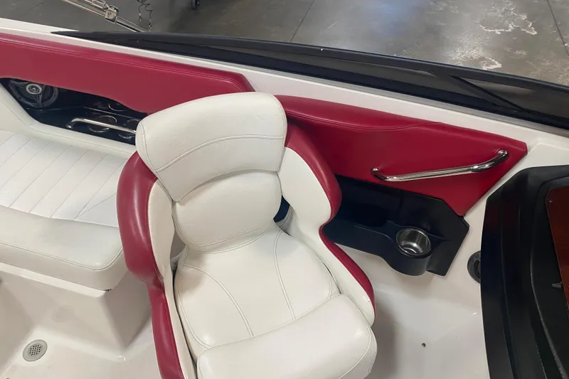Slide: The Image of 2008 Regal 2000 Bowrider interior with white and red seating, cup holder, and chrome handle. - 14