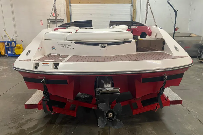 Slide: The Image of 2008 Regal 2000 Bowrider boat in a garage, rear view with propeller visible. - 4