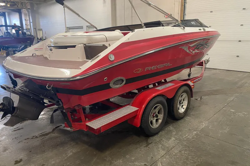 Slide: The Image of Red 2008 Regal 2000 Bowrider boat on trailer in indoor storage. - 8
