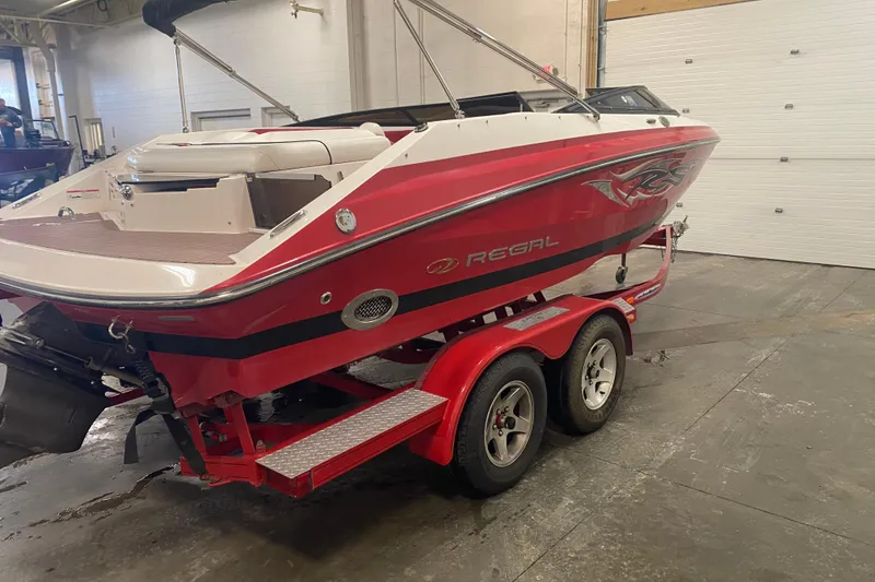 Slide: The Image of Red 2008 Regal 2000 Bowrider boat on trailer in indoor storage facility. - 9