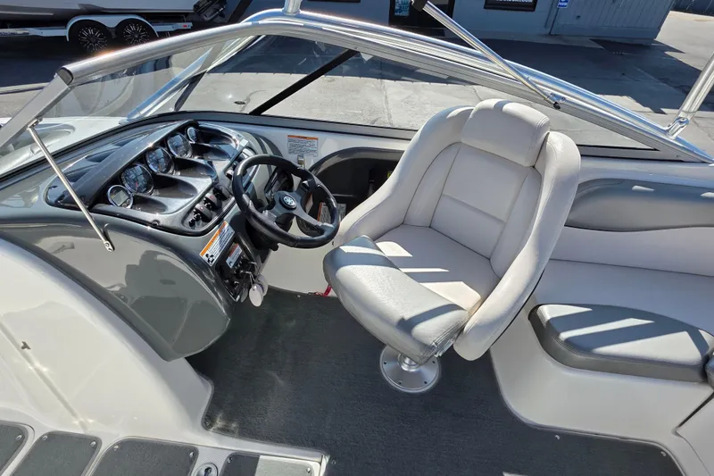 Slide: The Image of 2009 Yamaha Boats AR210 interior with steering wheel and captain's seat. - 13