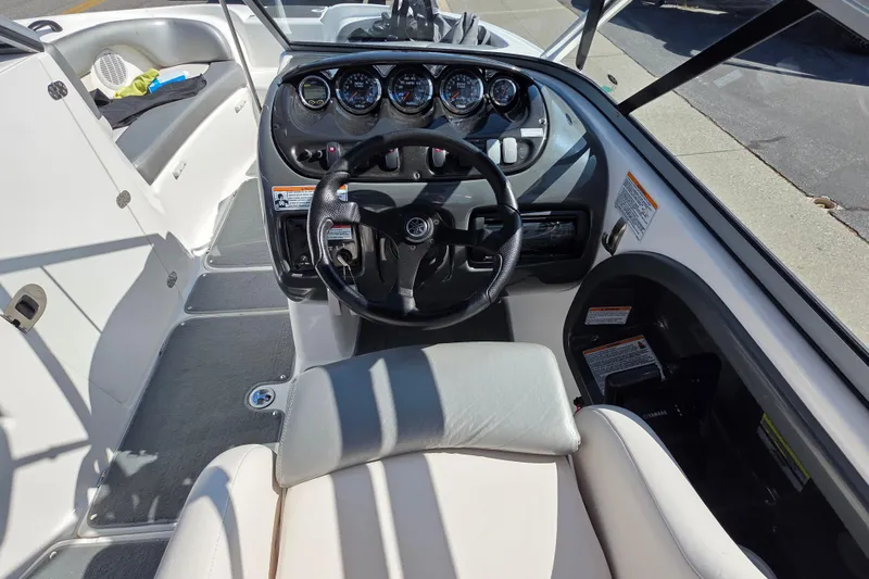Slide: The Image of 2009 Yamaha Boats AR210 cockpit with steering wheel and instrument panel. - 14
