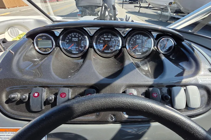 Slide: The Image of Dashboard of a 2009 Yamaha Boats AR210, featuring gauges and controls. - 15
