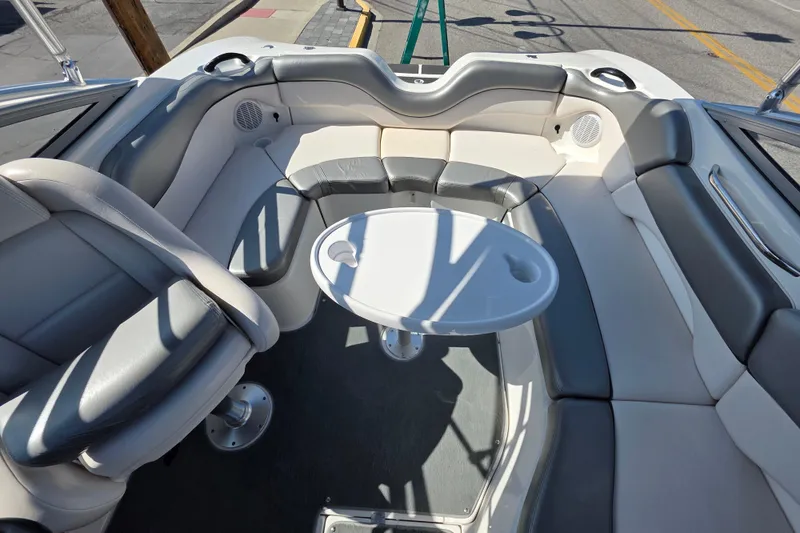 Slide: The Image of 2009 Yamaha Boats AR210 interior with gray seating and round table. - 18