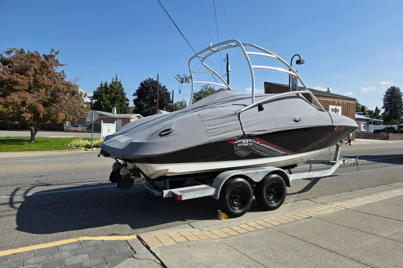 Slide: The Image of 2009 Yamaha AR210 boat on trailer, covered, parked on street. - 5