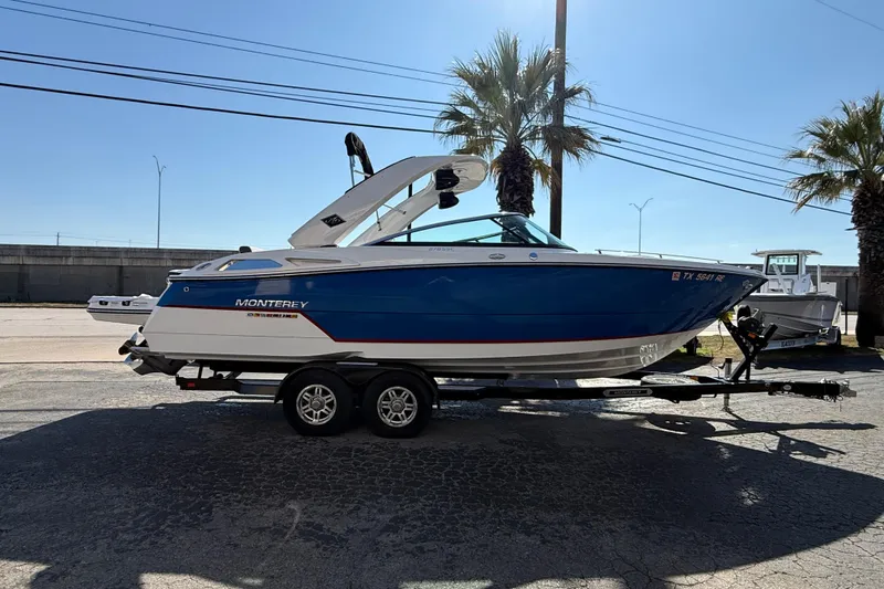 The Image of 2018 Monterey 278 SSC boat on trailer, parked outdoors under clear sky. - 1