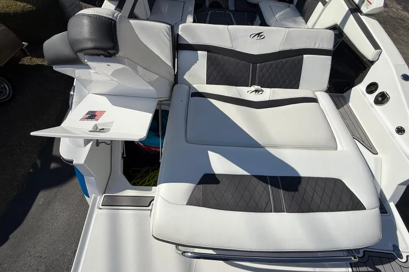 Slide: The Image of 2018 Monterey 278 SSC boat interior with white and black seating, American flag detail. - 10