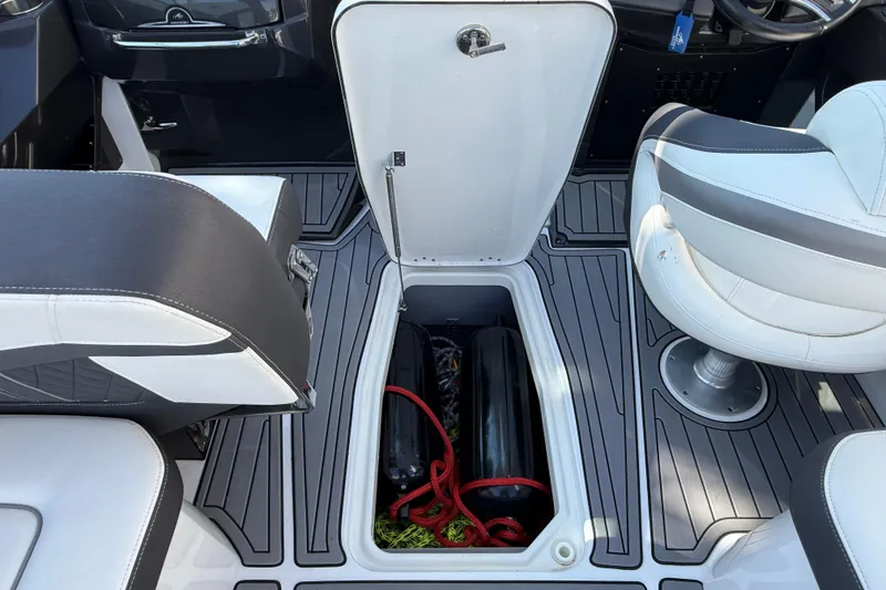 Slide: The Image of 2018 Monterey 278 SSC boat interior with open storage compartment and seating. - 13