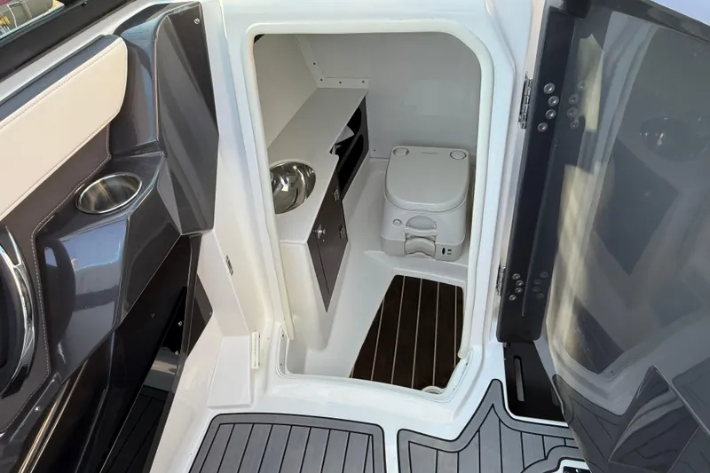 Slide: The Image of 2018 Monterey 278 SSC boat interior with compact bathroom and modern amenities. - 16