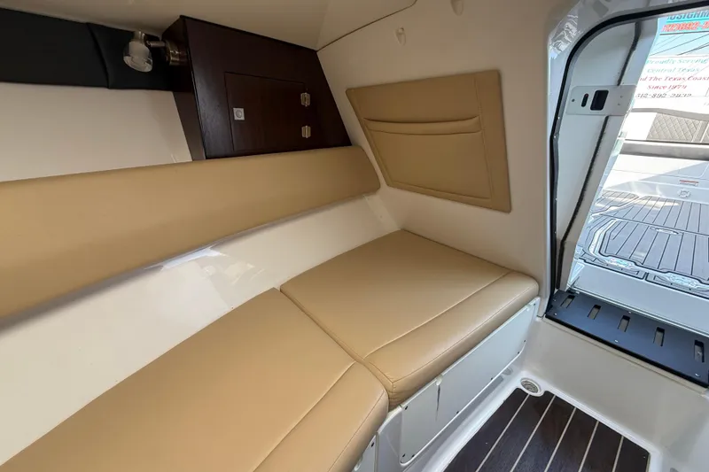 Slide: The Image of Interior cabin of 2018 Monterey 278 SSC boat with beige seating and wooden accents. - 18