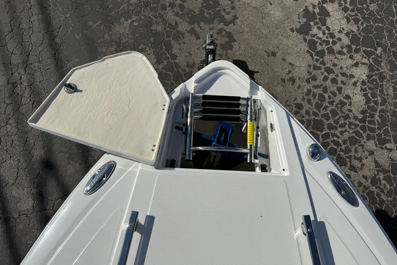 Slide: The Image of 2018 Monterey 278 SSC boat bow with open hatch and ladder on asphalt. - 19