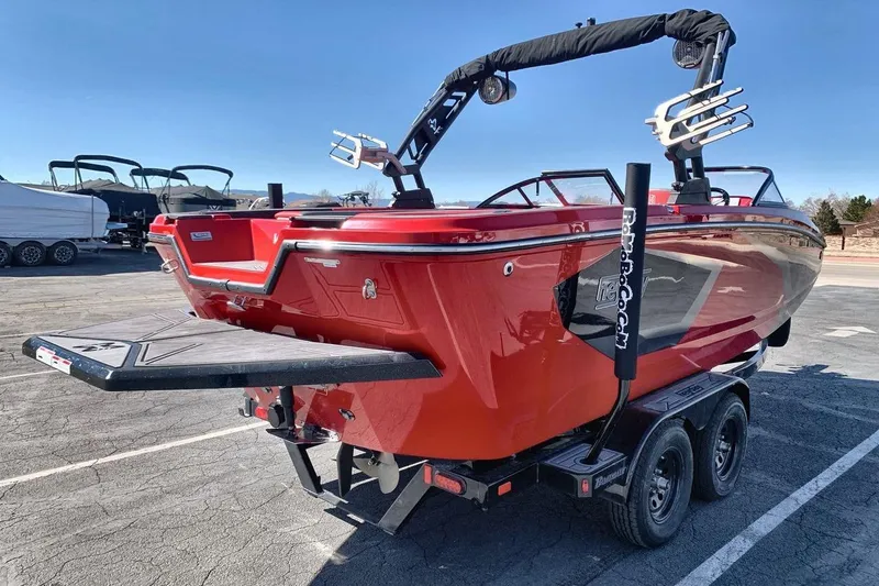 Slide: The Image of 2023 Heyday WT-2DC red boat on trailer, parked outdoors under clear sky. - 15