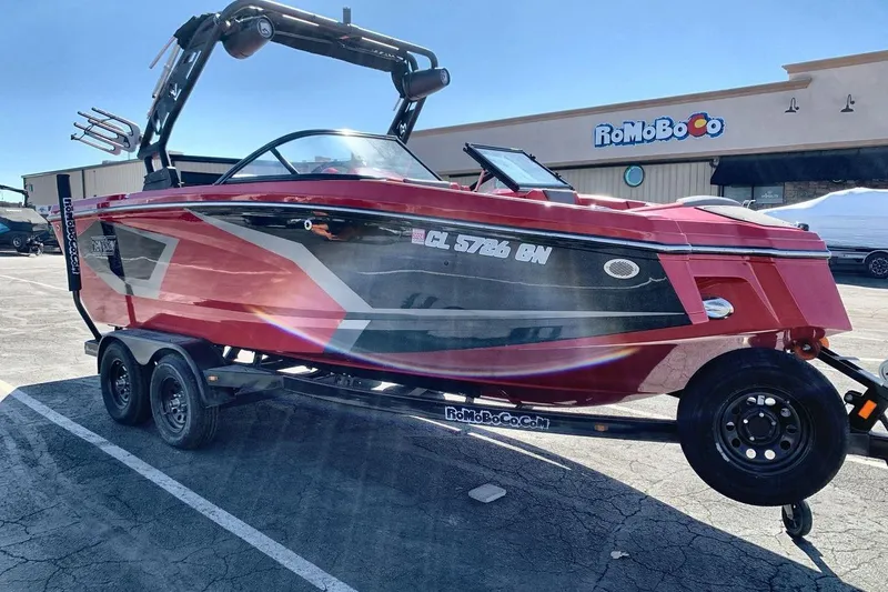 Slide: The Image of 2023 Heyday WT-2DC boat on trailer, parked in a lot, with vibrant red and black design. - 17