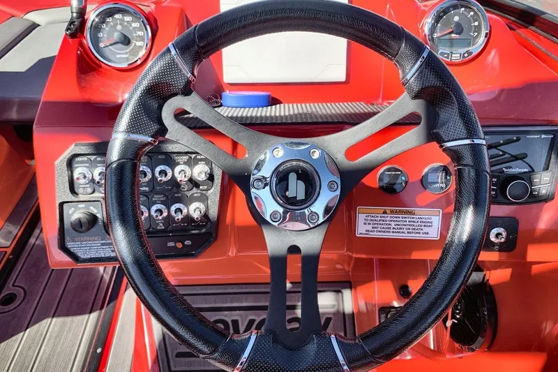 Slide: The Image of Steering wheel and dashboard of 2023 Heyday WT-2DC boat, featuring gauges and controls. - 24