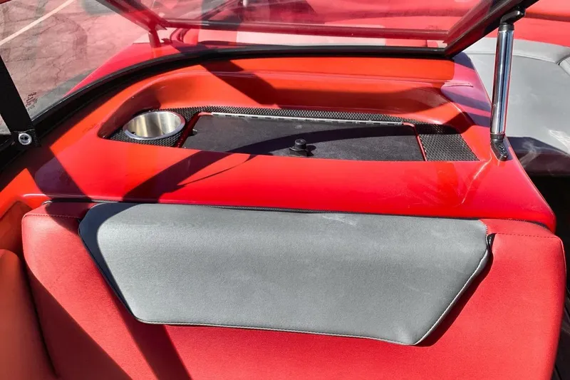 Slide: The Image of 2023 Heyday WT-2DC boat interior with red and gray seating, cup holder, and windshield. - 28