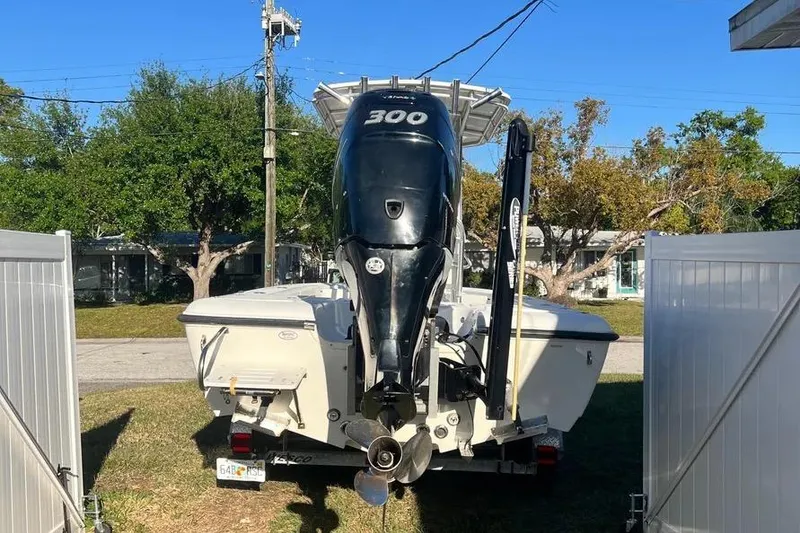 Slide: The Image of 2010 Key West 246 Bay Reef boat with 300 HP engine, parked outdoors. - 10