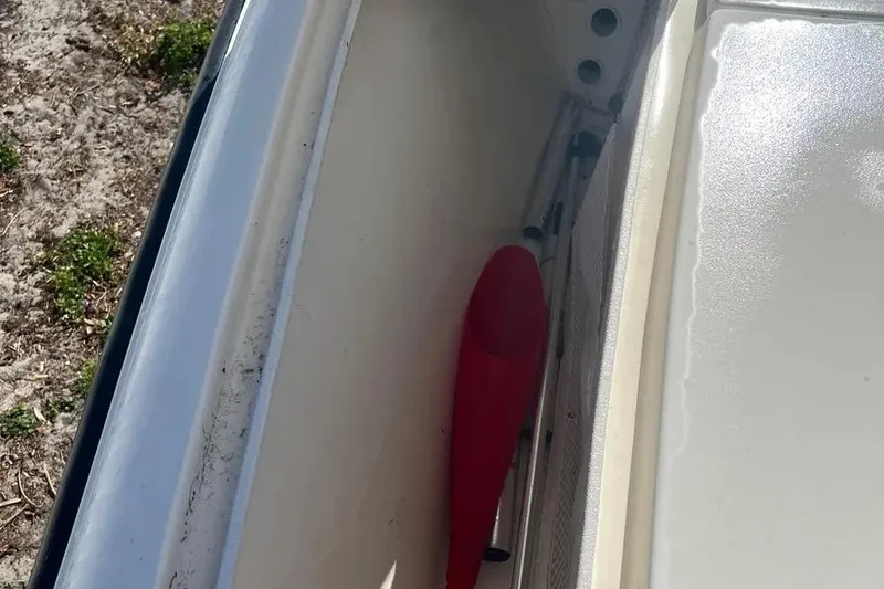 Slide: The Image of Interior view of a 2010 Key West 246 Bay Reef boat compartment with red paddle. - 13