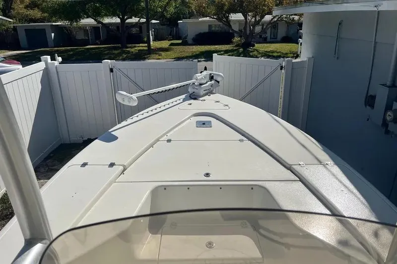 Slide: The Image of 2010 Key West 246 Bay Reef boat docked in a fenced yard. - 14