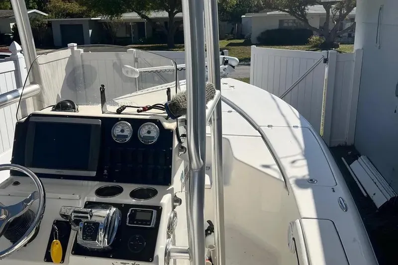 Slide: The Image of 2010 Key West 246 Bay Reef boat interior with steering console and gauges. - 15