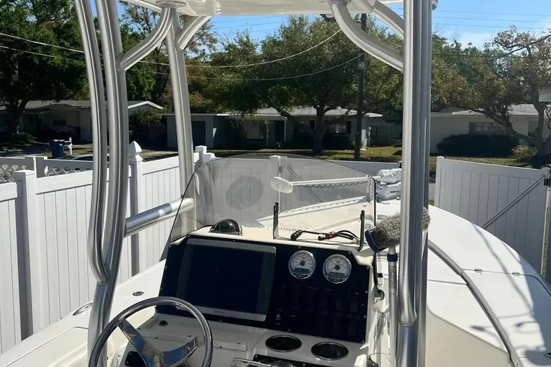 Slide: The Image of 2010 Key West 246 Bay Reef boat interior with steering console and gauges. - 16