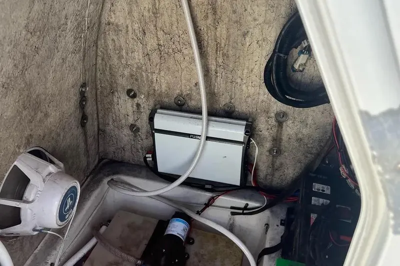 Slide: The Image of 2010 Key West 246 Bay Reef boat interior with electronic components and wiring. - 18