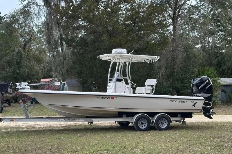 The Image of 2010 Key West 246 Bay Reef boat on trailer, parked outdoors. - 2