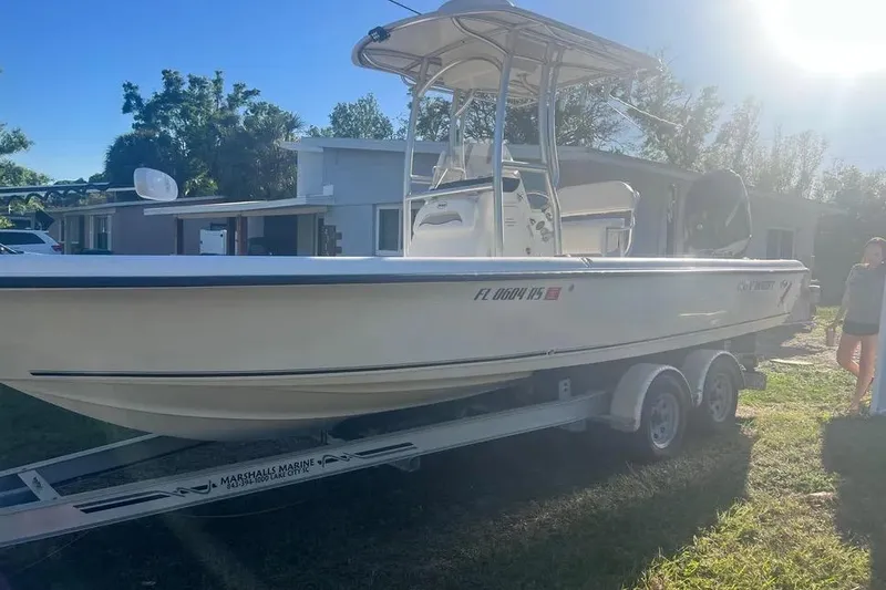 Slide: The Image of 2010 Key West 246 Bay Reef boat on trailer in sunny residential area. - 4