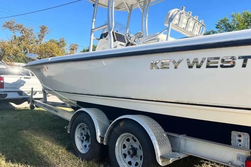 Slide: The Image of 2010 Key West 246 Bay Reef boat on trailer, parked outdoors. - 6