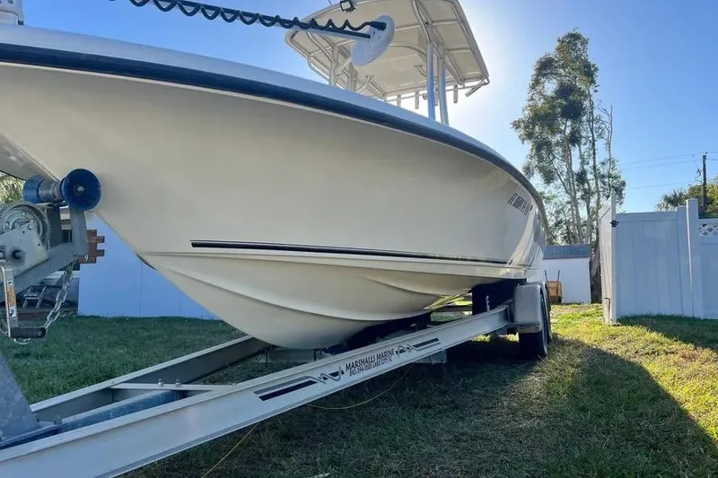 Slide: The Image of 2010 Key West 246 Bay Reef boat on trailer in sunny yard. - 7