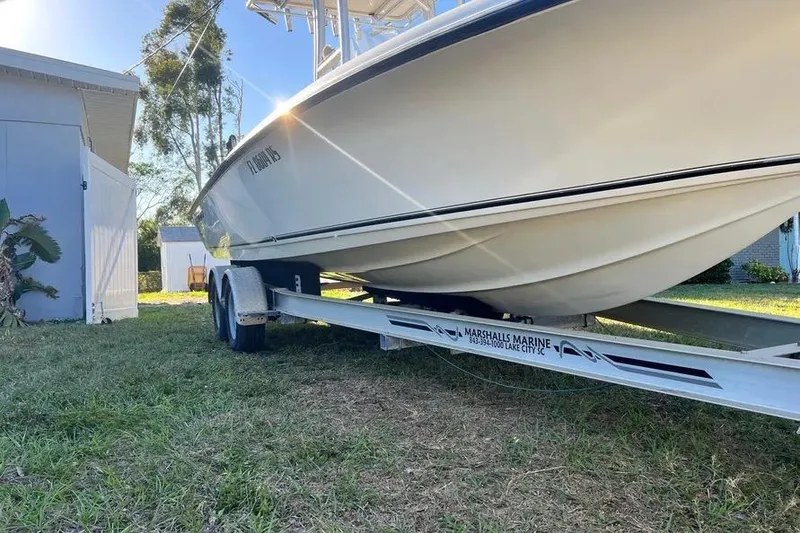 Slide: The Image of 2010 Key West 246 Bay Reef boat on trailer, parked outdoors in sunlight. - 8