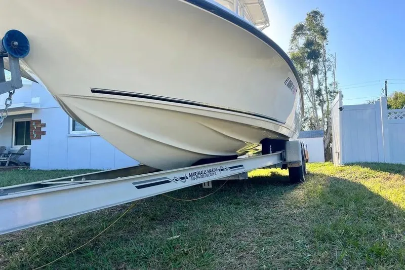 Slide: The Image of 2010 Key West 246 Bay Reef boat on trailer in residential yard. - 9