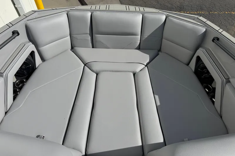 Slide: The Image of 2026 Moomba Max boat interior with gray cushioned seating and cup holders. - 7