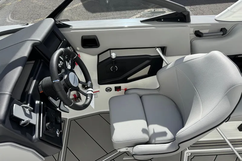 Slide: The Image of 2026 Moomba Max boat interior with steering wheel and comfortable seating. - 9