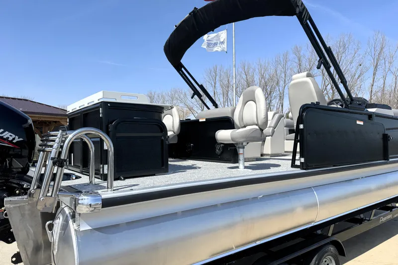 Slide: The Image of 2026 Premier 230 Sunsation Angler 2pt pontoon boat with seating and canopy, docked outdoors. - 10