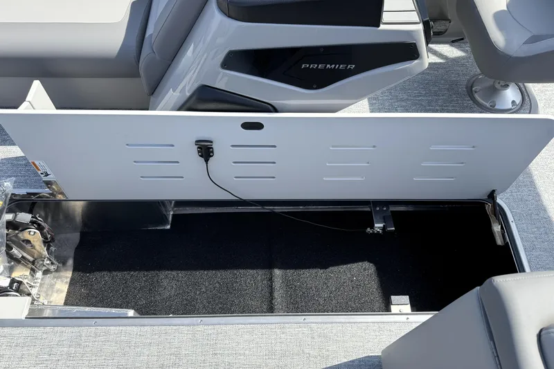 Slide: The Image of Open storage compartment in 2026 Premier 230 Sunsation Angler 2pt boat interior. - 14