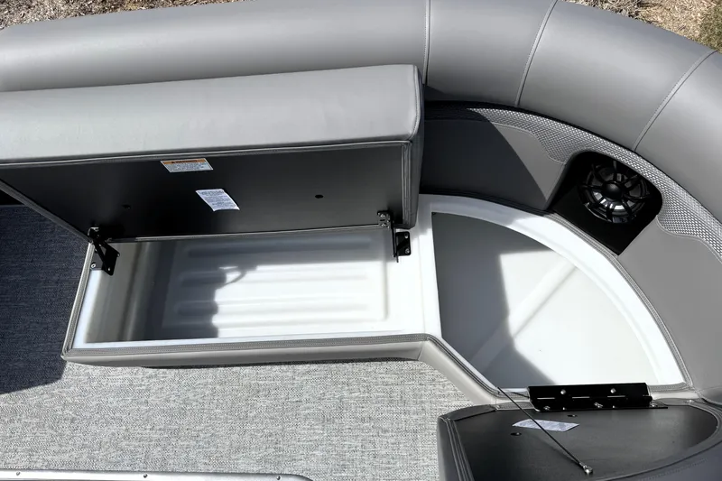Slide: The Image of Open storage compartment on 2026 Premier 230 Sunsation Angler 2pt boat with gray seating. - 23