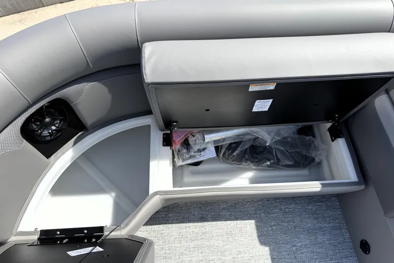 Slide: The Image of 2026 Premier 230 Sunsation Angler 2pt boat interior storage compartment with gray seating. - 24
