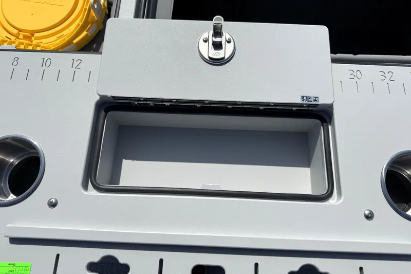 Slide: The Image of Premier 230 Sunsation Angler 2pt 2026 boat console with storage compartment and measuring scale. - 35