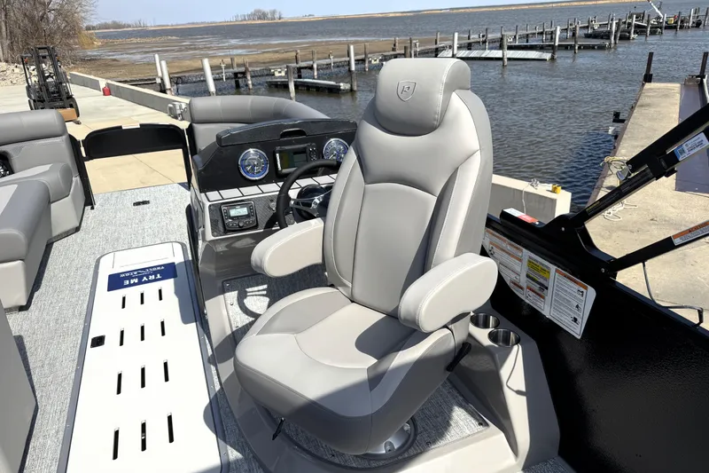 Slide: The Image of 2026 Premier 230 Sunsation Angler 2pt boat interior with captain's chair and control panel. - 41