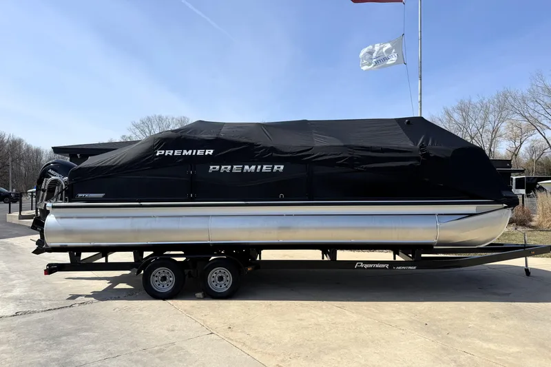 Slide: The Image of 2026 Premier 230 Sunsation Angler 2pt pontoon boat on trailer, covered and parked outdoors. - 44
