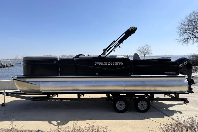 Slide: The Image of 2026 Premier 230 Sunsation Angler 2pt pontoon boat on trailer by waterfront. - 5